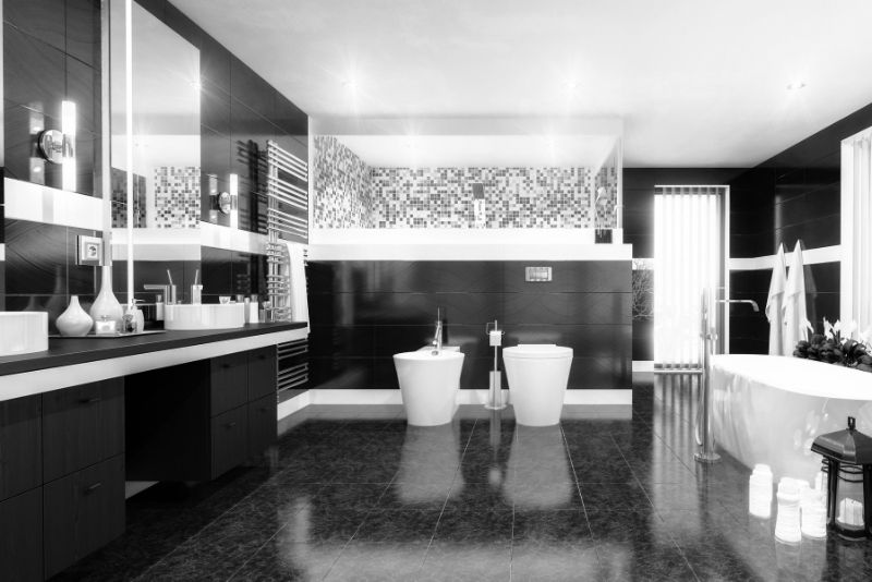 Black-themed bathroom renovation with tiled walls and modern fixtures