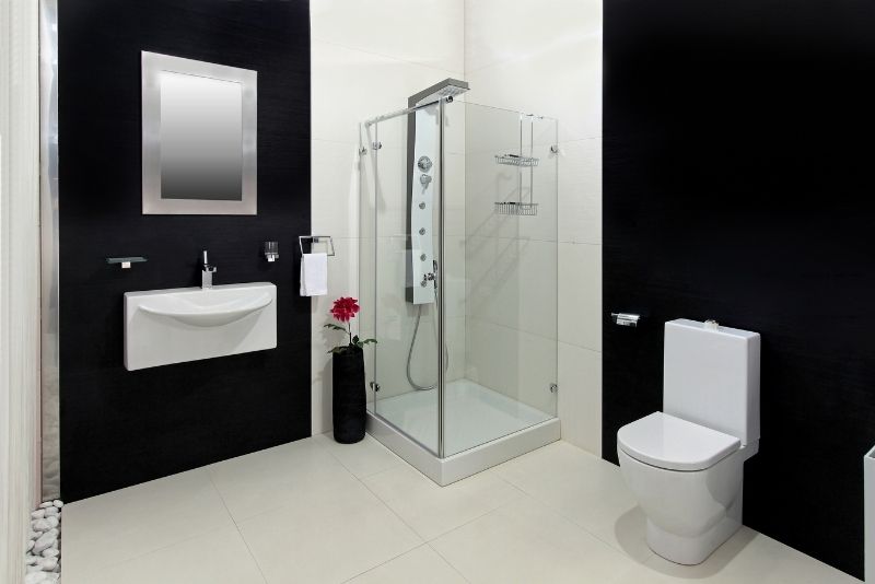 Small bathroom with a shower, compact sink and toilet