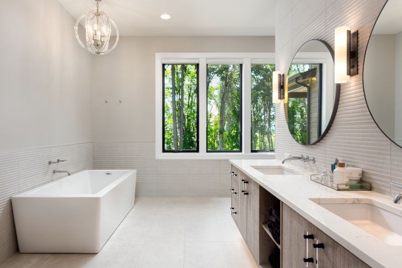 A bathroom with mirrors and a bathtub