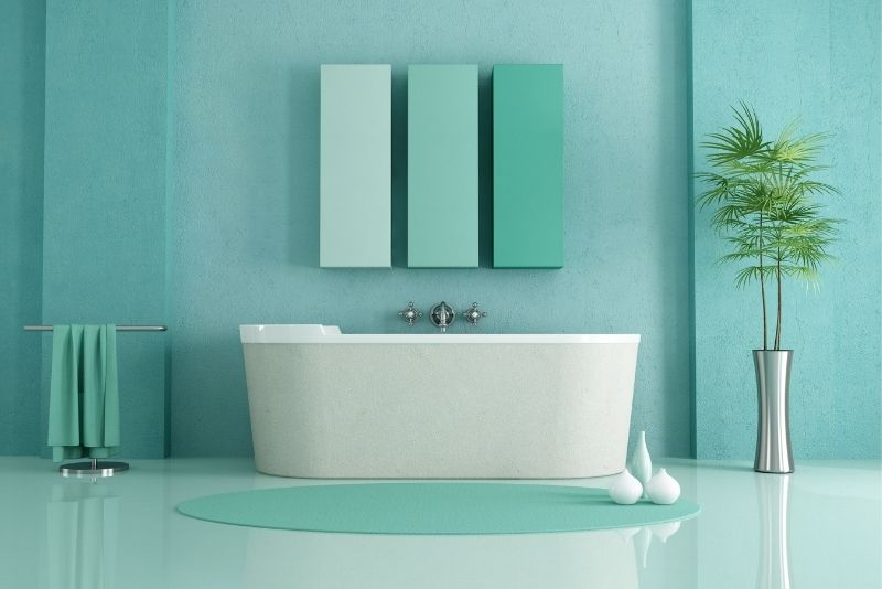 A bathroom with a bathtub and blue walls