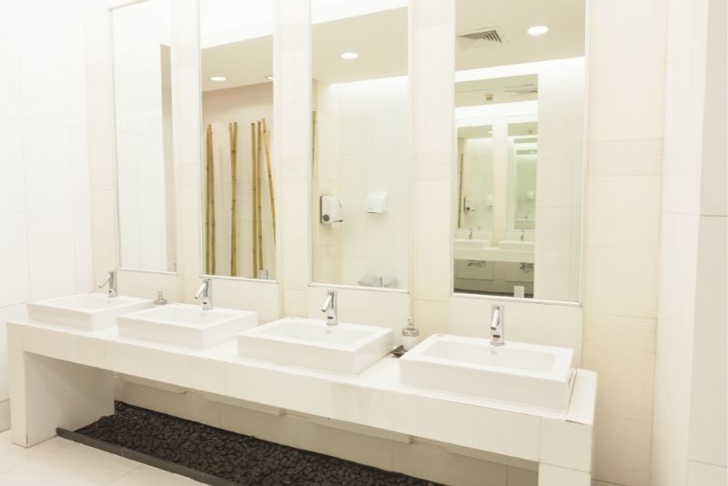 A commercial bathroom with a white colour theme