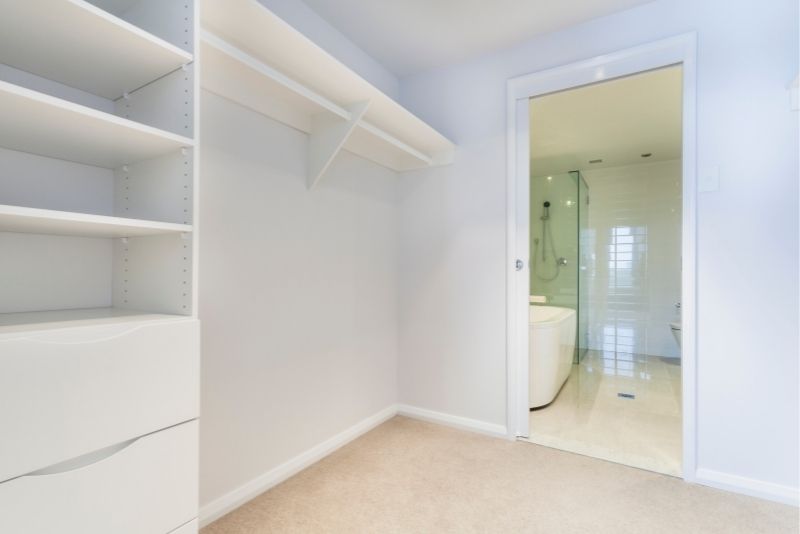 An ensuite bathroom with glass door