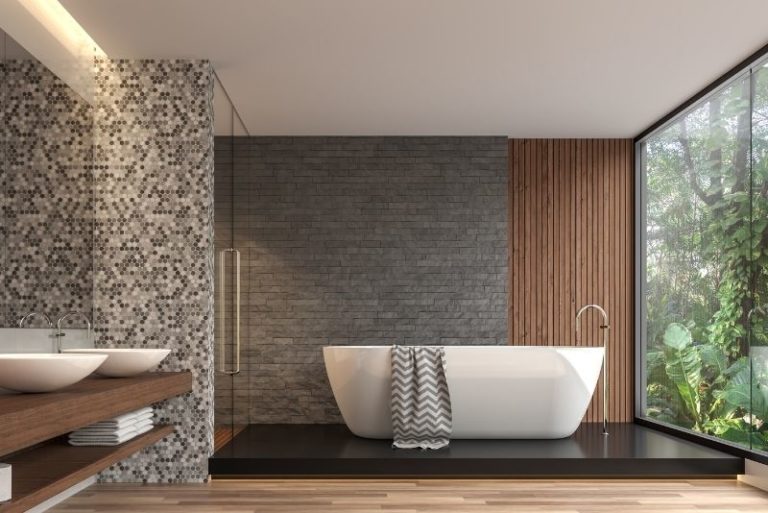 Grey-tiled bathroom with renovated bathtub